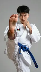 Karate Karateka Wearing Blue Belt Quick Kicking Spin Kick In