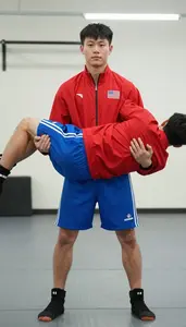 Sambo Competitor In Red Or Blue Jacket And Shorts Throwing A