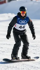 Snowboard Cross Athlete In Insulated Suit Racing Down A