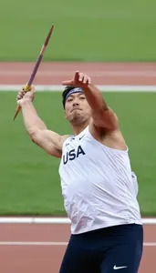 Javelin Thrower In A White Vest Spins And Releases Body