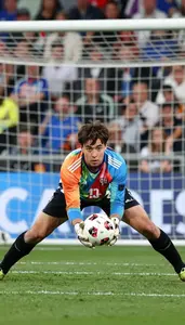 Soccer Goalkeeper In Gloves And A Colorful Kit Dives Full