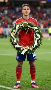 Soccer Striker Wearing Cleats Celebrating Holding Victory