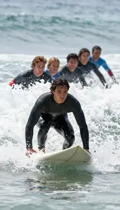 Surfer In A Steamer Wetsuit Paddles Back Out After A Wave