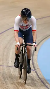 Track Cyclist In Tight Jersey And Muscular Legs Sprinting