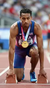 Athletics Sprinter Wearing Singlet Displaying Holding