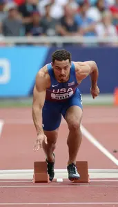 Athletics Sprinter Wearing Singlet Focused Striding Block