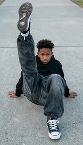 B Boy In Baggy Pants And Sneakers Freezing In A Complex