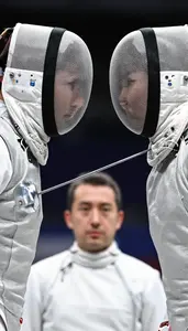 Fencer And Opponent Face Off Both In White Masks Under Arms