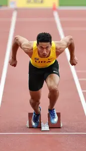 Sprinter In A Bright Yellow Vest And Black Briefs Reacts