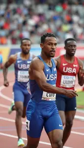 Sprinter In A National Team Vest Looks Over Their Shoulder