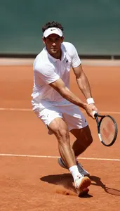 A Tennis Player In A Crisp Polo And Shorts Is Frozen Mid
