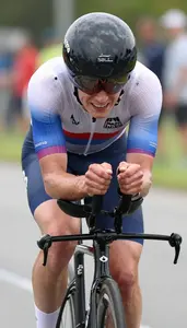 Air Bike Sprinter In Soaked Shirt And Grimacing Expression