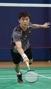 Badminton Aggressor Wearing Wristband Focused Net Shot Half