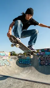 Skateboarder In A Beanie And Baggy Jeans Rides A Halfpipe