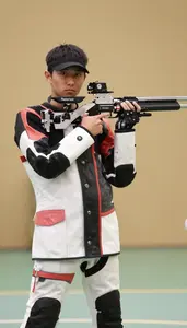 Air Rifle Shooter In Shooting Jacket And Specialized Pants