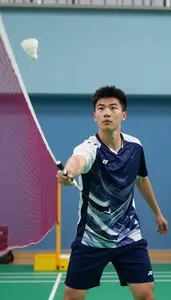 Badminton Singles Player Wearing Jersey Determined Net Shot