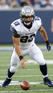 Football Linebacker Wearing Game Pants Intense Tackling