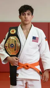 Judo Specialist Wearing Orange Belt Standing With Pride