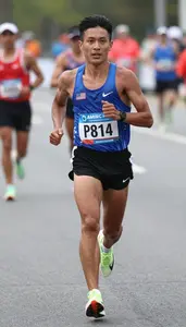 Marathon Pace Runner Wearing Number Bib Determined Sprinting