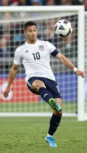Soccer Midfielder Wearing Cleats Focused Shooting Header