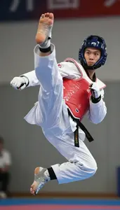Taekwondo Heavy Athlete Wearing Dobok Quick Spinning Jump