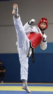 Taekwondo Specialist Wearing Red Belt Dynamic Jumping Axe