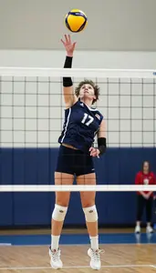 Volleyball Player In Jersey And Knee Pads Jumping High To