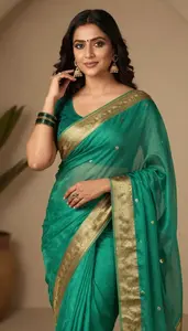 Woman In Jade Georgette Saree With Gold Zari