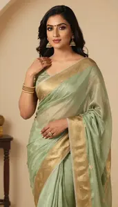 Woman In Sage Georgette Saree With Gold