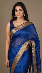 Woman In Sapphire Silk Saree With Gold Border