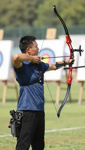 Archery Instructor Shooting An Arrow At At An Archery Range At Work Location