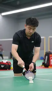 Badminton Coach Shutting A Badminton Shuttlecock At A Badminton Court In