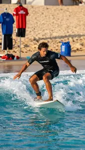 Diving Coach Surfing On A Wave In An Olympic Size Swimming Pool At Professional