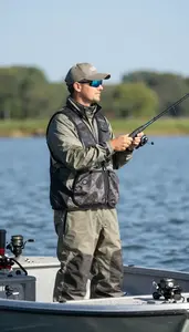 Hunting Instructor Fishing From A Boat On A Lake Fishing Spot At Professional