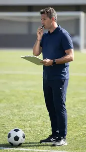 Soccer Coach Coaching A Soccer Team On A Soccer Match Field At Professional