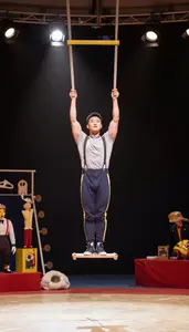Stand Up Comedian Performing On A Trapeze On A Circus Trapeze High Above The