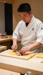 Sushi Chef Serving Sushi With Precision At A Sushi Bar Counter In Daily Work