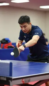 Table Tennis Coach Hitting A Table Tennis At A Table Tennis Table At Workplace