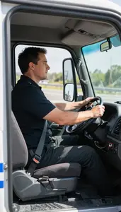 Truck Driver Driving A Police Car Inside A Truck Cab On A Highway In Daily Work