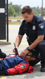 K9 Unit Officer Providing Emergency Medical Care At A Border Crossing Checkpoint