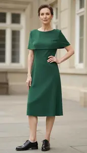 Fashion Forward Forest Green Covered Shoulder Dress Stock Photo