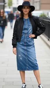 Polished Woman In Distressed Denim Dress Stock Photo