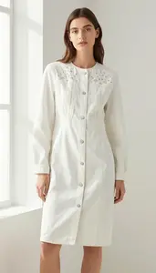 Woman In Mid 20s Poised Woman In White Embroidered Denim Dress