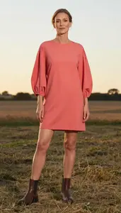 Woman In 50s Well Dressed Woman In Coral Lantern Sleeve Casual Dress