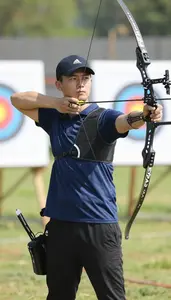 Archery Instructor Shooting An Arrow At At An Archery Range At Professional