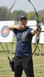 Archery Instructor Shooting An Arrow At At An Archery Range At Work Today