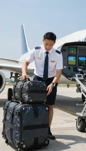 Aviation Dispatcher Loading Baggage Onto An On An Airport Runway During
