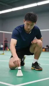 Badminton Coach Shutting A Badminton Shuttlecock At A Badminton Court At Work