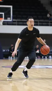 Basketball Coach Dribbling A Basketball On On A Basketball Court In Daily Work