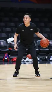 Basketball Coach Dribbling A Basketball On On A Basketball Court In Professional